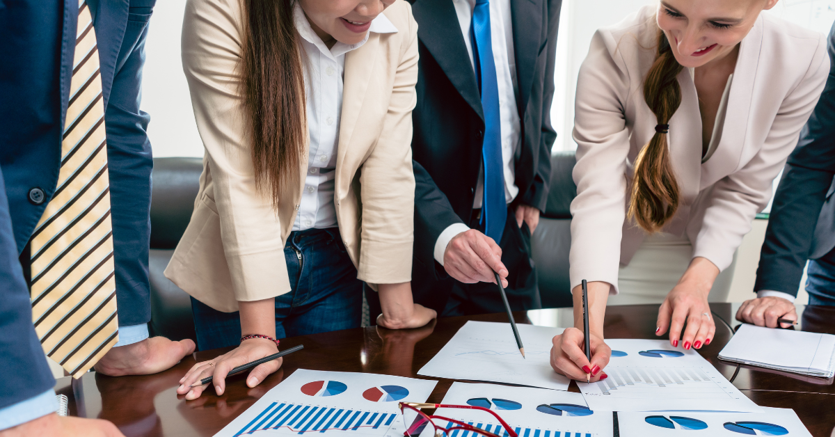 close up of people discussing financial documents